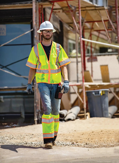 Mens Built Tough High Visibility Mesh Vest With Six Cargo Pockets And Secure Zipper Ansi Class Three worn on a construction site.