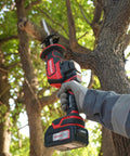 Person using Beast 20V Max Brushless Cordless Recip Saw With LED Light 3100 RPM 5Ah Battery And Fast Charger outdoors on tree limb.