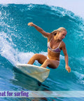 AquaBlock Silicone Ear Plugs For Swimming 2 Pair Waterproof Reusable Ear Protection in use by woman surfing in ocean