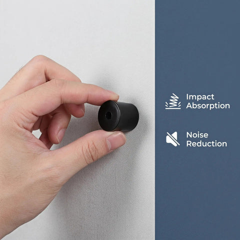 Hand holding black rubber door stop from Set Of 10 Black Rubber Door Stops With Stable Wall Mount And Anti Slip Pads For Noiseless Quiet Shock Absorbing Door Buffers Ideal For Office Partitions And Hotel Rooms With Silent Operation And Durable As Heck Build on wall demonstrating impact absorption and noise reduction