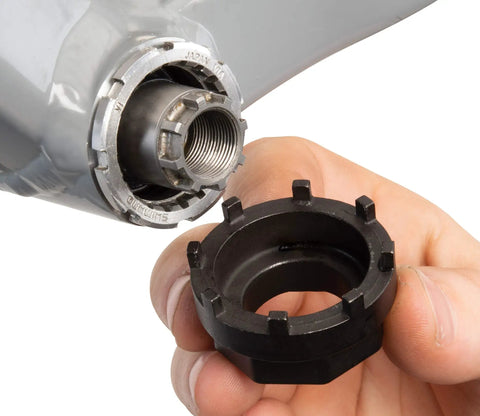 Hand holding Bottom Bracket Tool BBT-18 For 8-Notch BBs, 43.4mm Outer Diameter And 38mm Width, 3.9mm Notch, Center Hole 22.5mm