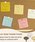 Super Solid Bronze Flat Head Upholstery Thumb Tacks For Walls And Wood Furniture 100 Pack Of Heavy Duty Push Pin Nails used on a corkboard with notes.