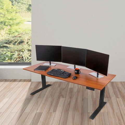 Heavy Duty Electric Standing Desk With Programmable Memory, smooth dual motor lift, 72 inch warm teak surface, in an office setup.