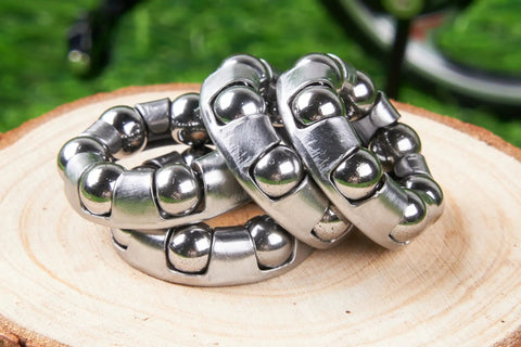 Beefy One Inch Bicycle Ball Bearings Set For Front And Rear Hubs With Seven Steel Balls In A Fixed Cage Inner Diameter Zero Point Fifty Five Inches Ball Diameter One Quarter Inch Durable Steel Retainer Fits 4 10 20 Pack shown stacked on wooden surface