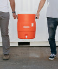 10 Gallon Portable Sports Cooler And Beverage Dispenser With Flat Seat Lid Insulated For All Day On The Go Chillin, carried by two people.