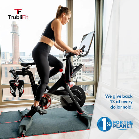 Woman using stationary bike indoors with Replacement Bike Cleats For Cycling Shoes Compatible With Look Delta And Peloton