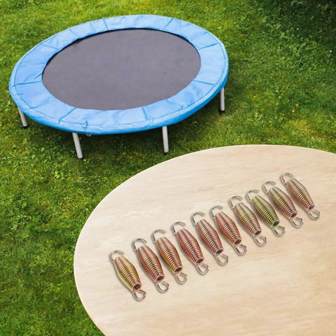 Heavy Duty Extension Springs 10 Pack Steel Coil Load Up To 50kg For Garage Doors Trailer Ramps Farm Gear Durable Carbon Steel Build That Holds Tight arranged on a table with a trampoline in background.