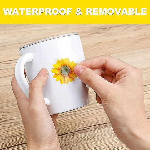 Applying a sunflower decal from the 39 Piece 3D Sunflowers And Butterflies Wall Decals Set With Gold Accents to a mug