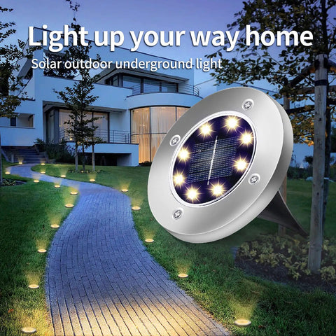 Garden path illuminated by Solar Ground Lights 12 Pack With 8 LED Waterproof Disk Pathway Lights For Yard Walkway Patio And Lawn.