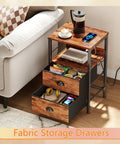 Sleek Rustic Brown Nightstand With Built In Charging Station And Two Fabric Drawers A Legit Game Changer For Dorm Rooms Featuring No Sweat Setup With Standard Outlets And USB Ports For All Your Gear next to a sofa with items on top and in drawers.