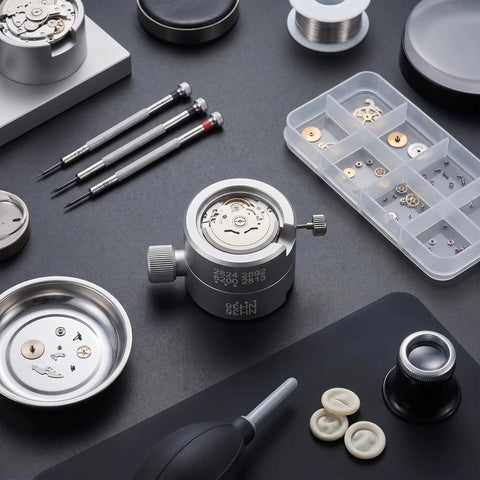 Watch Movement Holder And Base Repair Stand For 2824 2892 8200 2813 NH35 NH36 Movements on workbench with tools.