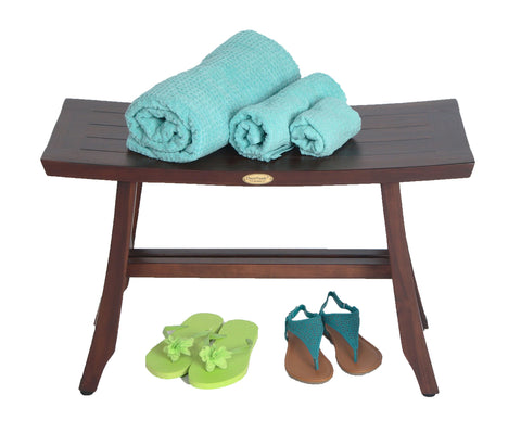 Satori Teak Shower Bench for Adults and Seniors, 24 Inch Compact Bath Seat with Brown Finish, with towels and sandals on it.