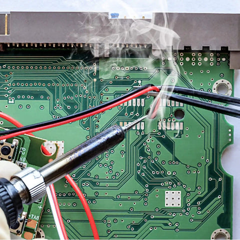 Soldering iron on circuit board with Tin Lead Solder Wire Kit With Rosin Paste Flux 60-40 Core Solder 0.8mm Diameter 50g, red and black wires