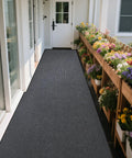 Heavy Duty Indoor Outdoor Entrance Mat 4 By 10 Feet Rubber Border Door Rug on porch with flowers, textured charcoal grey surface.