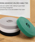 Heavy Duty Reusable Cable Management Straps White Tearable Cord Organizer Tie For Computer Speaker Guitar Wires on a wooden surface.