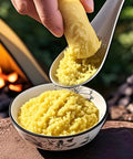 Using Ginger Grater Spoon And Lime Zester With Garlic Press to prepare ginger puree over stove, showcasing its versatility.