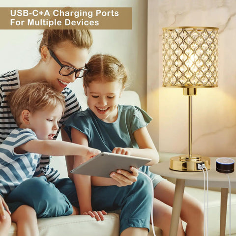 Dope Crystal Table Lamp With USB C And USB A Ports Touch Dimmer Bedside Lamp in gold next to a family on a couch.