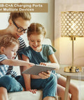 Family beside Crystal Touch Control Table Lamp with USB-C and USB-A Charging Ports, dimmable in gold shade for cozy mood lighting.