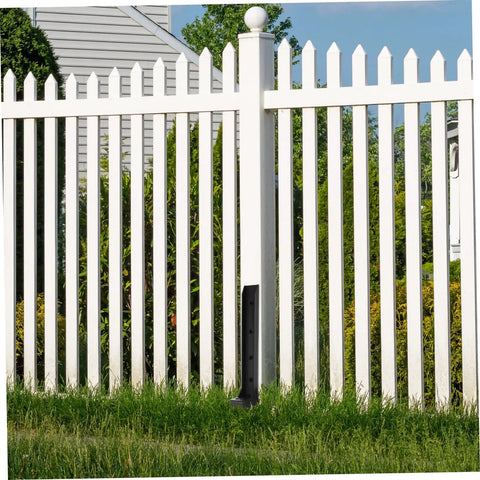 Installed Heavy Duty Fence Post Repair Stakes Ground Spike Anchor Kit Weather Resistant For Quick Installation And Rock Solid Fence Support In Garden Backyard Patio And Yard Two Pack next to a white vinyl fence.