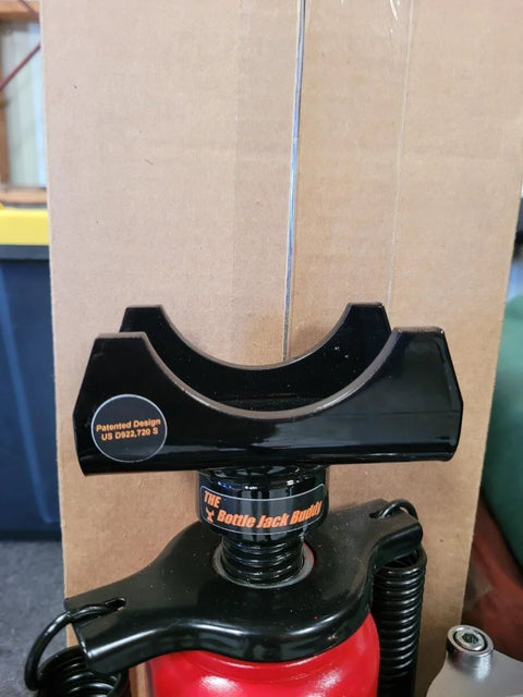 Three Inch Axle Saddle For Bottle Jacks Built Tough Safe No Nonsense Lifting Aid Compact Steel Design attached to jack