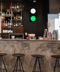 Remote Control Traffic Light Wall Lamp With Red And Green LED DC Nine To Twelve Volt Plug Included Aluminum Frame Ultra Bright Sign Light For Home Office Bar Decor Adjustable Light Angle And Easy Install in a bar setting with a fluorescent green light illuminated.