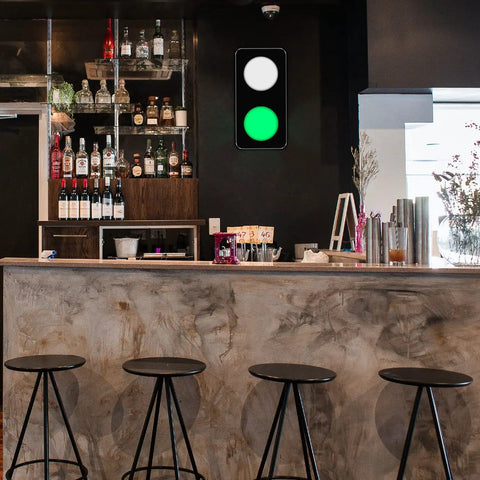 Remote Control Traffic Light Wall Lamp With Red And Green LED DC Nine To Twelve Volt Plug Included Aluminum Frame Ultra Bright Sign Light For Home Office Bar Decor Adjustable Light Angle And Easy Install in a bar setting with a fluorescent green light illuminated.