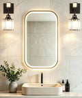 BANGANMA 2-Pack Black Farmhouse Hardwired Wall Sconces Crystal for Bathroom over a modern sink with a mirror and plants.