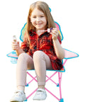 Child sitting on Ice Cream Themed Kids Folding Camp Chair With Cup Holder And Carry Bag Lightweight Portable Seat For Indoor And Outdoor Use