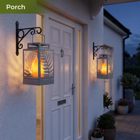 Outdoor Solar Lanterns With Flickering Flame 2 Pack Rustproof Metal LED Lights on porch wall, warm glow at dusk.