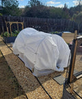 Mini greenhouse with shade cloth on raised bed, supported by Six Pack Of 7 Foot Fiberglass Greenhouse Hoops For Raised Beds Rust Proof Garden Netting Support Small Greenhouse Kit For Shade Cloth And Plant Row Covers 30 Pieces.
