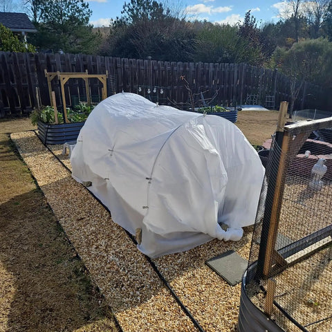 Mini greenhouse with shade cloth on raised bed, supported by Six Pack Of 7 Foot Fiberglass Greenhouse Hoops For Raised Beds Rust Proof Garden Netting Support Small Greenhouse Kit For Shade Cloth And Plant Row Covers 30 Pieces.