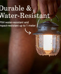Rechargeable 800 Lumen LED Lantern With Carabiner Handle And USB C Charging Ports For Camping Power Outages And Emergencies, held outdoors.