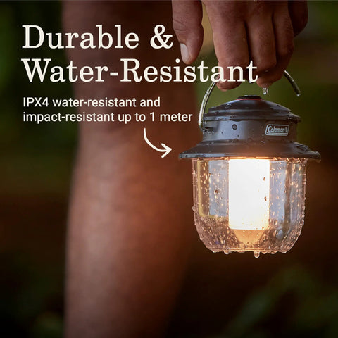 Rechargeable 800 Lumen LED Lantern With Carabiner Handle And USB C Charging Ports For Camping Power Outages And Emergencies, held outdoors.