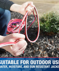 Person holding Beefy Built Tough Outdoor Extension Cord 50 Ft 12 Gauge 3 Conductor With Lighted End SJTW in red, white, blue