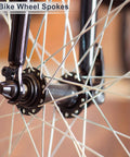 Close-up of universal bicycle spokes 12G 130mm length with 36 spokes and nipples in black carbon steel on a bike wheel.