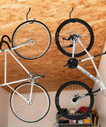 Heavy Duty Bike Storage Hooks For Garage, Wall And Ceiling Mounts showing two bikes hanging vertically from ceiling racks