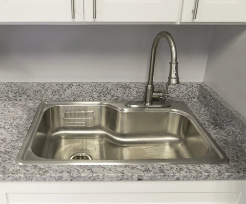 Single-Handle Pull-Down Kitchen Faucet With Sprayer In Satin Nickel installed over a stainless steel sink in a modern kitchen setting.