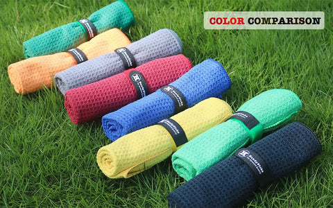 Eight colorful microfiber towels including Microfiber Golf Towel 16 By 16 Inches With Carabiner Clip Waffle Pattern on grass.