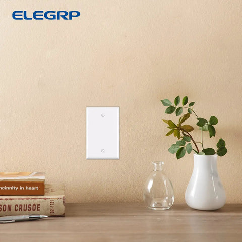 Built Tough Unbreakable 1-Gang Blank Device Wall Plate Set Mid Size 4.88-Inch High by 3.13-Inch Wide Glossy White Polycarbonate Faceplates For Unused Outlets And Switches UL Listed 5 Pack mounted on a wall.