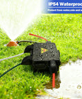Compact Outdoor Electrical Box With IP54 Weatherproof Cord Cover, Four-Port Enclosure For 12mm To 16mm Cables, Waterproof Extension Cord Organizer For Outdoor Power Setup, Keeps Cords Neat, Safe, And Ready To Roll. Black outdoor 4-port box on wet grass near sprinkler