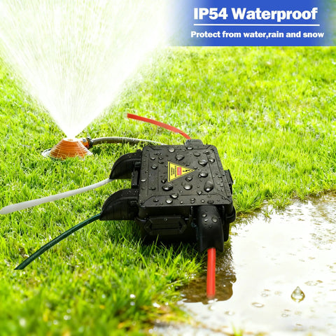 Compact Outdoor Electrical Box With IP54 Weatherproof Cord Cover, Four-Port Enclosure For 12mm To 16mm Cables, Waterproof Extension Cord Organizer For Outdoor Power Setup, Keeps Cords Neat, Safe, And Ready To Roll. Black outdoor 4-port box on wet grass near sprinkler