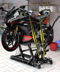 Motorcycle on Beefed Up 1500 Lbs Hydraulic Motorcycle Lift For Dirt Bikes ATVs And UTVs With Footplates Long Handle Four Wheels And Two Ratchet Belts 4.7 To 15 Inch Lifting Range Reliable Jack Stand in garage setting