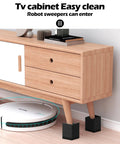 Give Your Bed Or Sofa A Legit Boost With These Heavy Duty Furniture Risers Featuring Adjustable Heights Anti Slip Grip Shock Absorbing Base And Rock Solid Support Handling Up To 1300 Lb Load In Sleek Black under a TV cabinet.