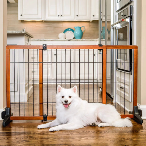 Extra Tall 28 Inch Freestanding Dog Gate, Super Wide 40 To 70 Inch Adjustable, Wooden Pet Gate For Doorways And Hallways, No Drill Setup, Sturdy Freestanding Design For Large Dogs, displayed with a white dog in front in a kitchen setting.