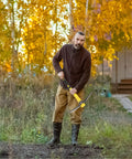 Man using Weeding Mattock Hoe 15 Inch Forged Garden Pick Axe With Fiberglass Handle Long Reach Tool in a garden