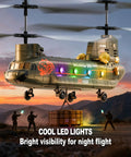 Remote Control Helicopter For Kids And Military Fans With Altitude Hold And One Key Takeoff And Landing LED Lights Two Easy Swap Modular Batteries With USB C Charging For About 20 Minutes Of Flight Lit RC Battery System Durable RC Toy in flight at sunset with LED lights and cargo