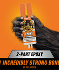 Front view of Gorilla 2-Part Epoxy syringe, clear, 0.85 oz, dual-cartridge held by a gorilla hand on orange background