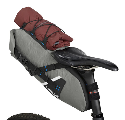 Mule 9 Bikepacking Rolltop Waterproof Saddle Bag For Tents And Gear With IPX5 Rating on bike, loaded with red tent, Wolf Grey 2.0.
