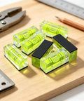 Magnetic Small Bubble Levels, multifunctional folding spirit level on wooden surface with tools and pencil.