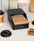 Black hot cup sleeve dispenser for coffee bar and kitchen organization, grab and go space saving coffee station accessory on counter.